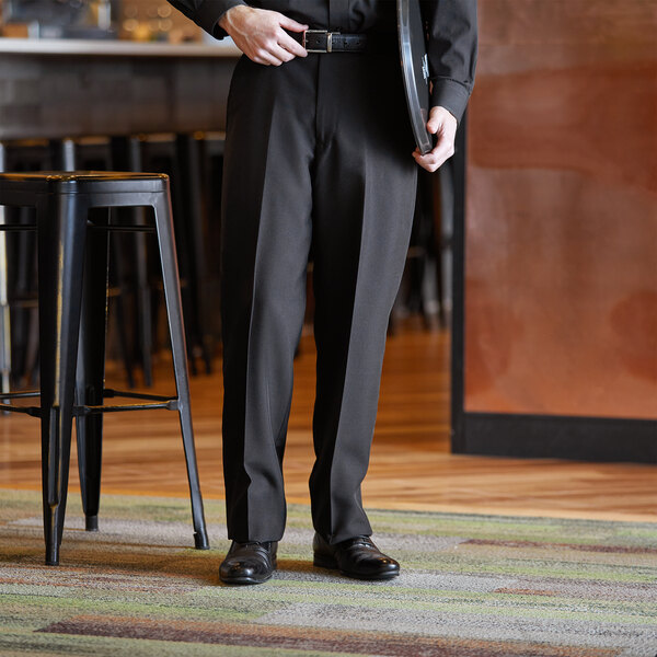 A woman wearing black Henry Segal customizable dress pants.