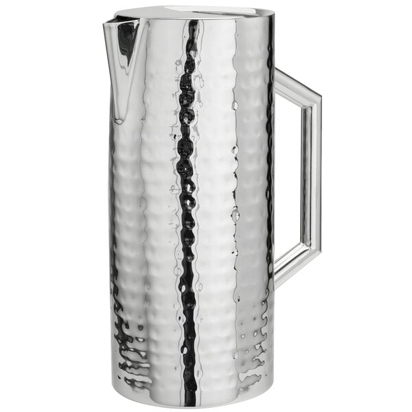 A Walco stainless steel pitcher with a handle.