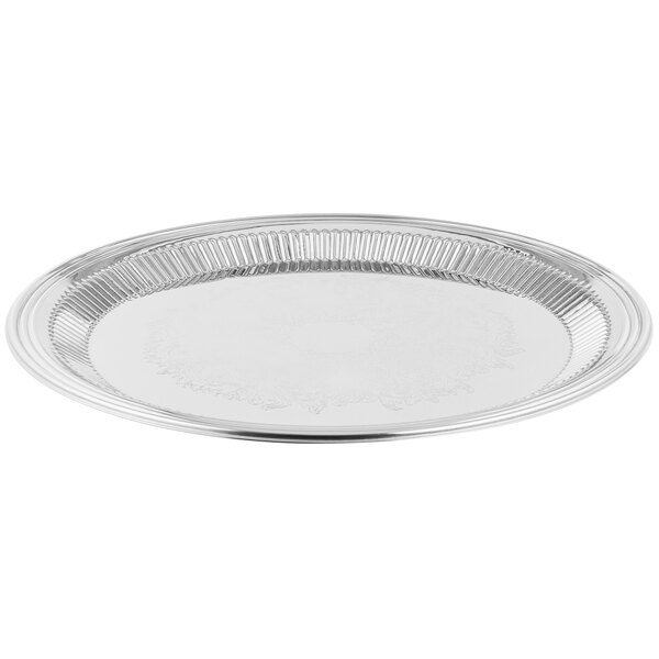 A Vollrath Esquire stainless steel round fluted tray with a round rim.