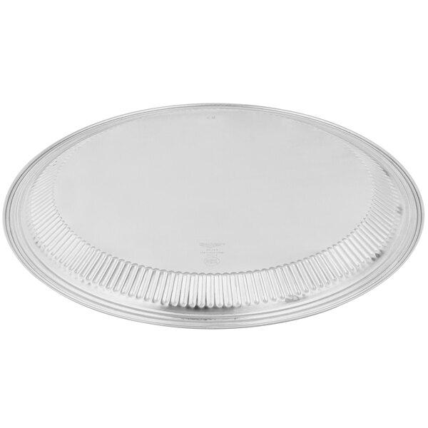 A Vollrath stainless steel round tray with a fluted edge.
