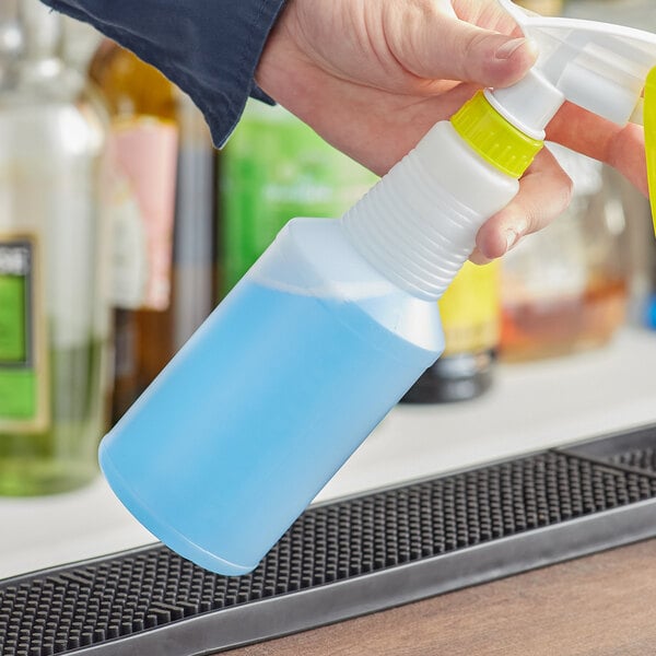 A hand holding a white plastic Off-Set Neck Molded bottle.