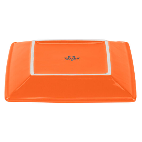 A papaya orange square Tuxton Concentrix china plate with a white border.