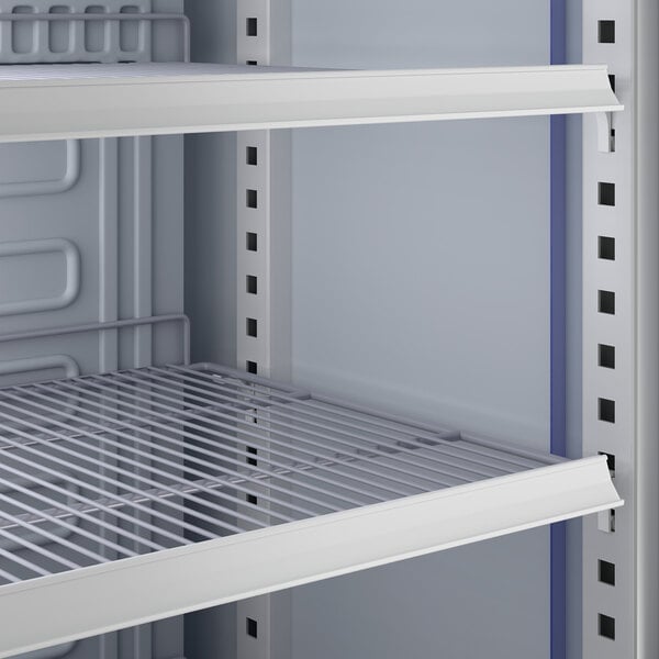 A close-up view of the interior wire shelving of a commercial glass door merchandiser refrigerator.
