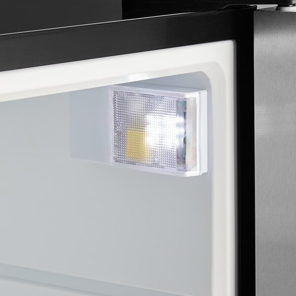 A close-up view of the interior light inside a Galaxy CRG-2 black customizable countertop display refrigerated merchandiser.