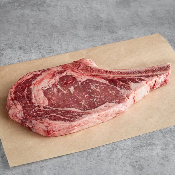 Raw bone-in ribeye steak