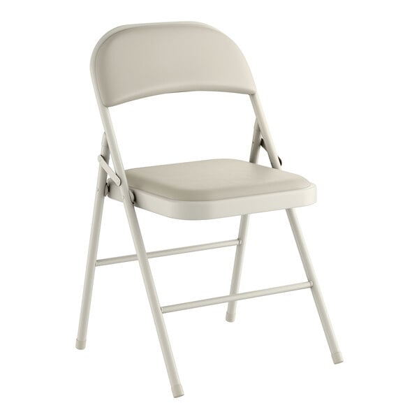 A beige vinyl folding chair with a padded seat and backrest.