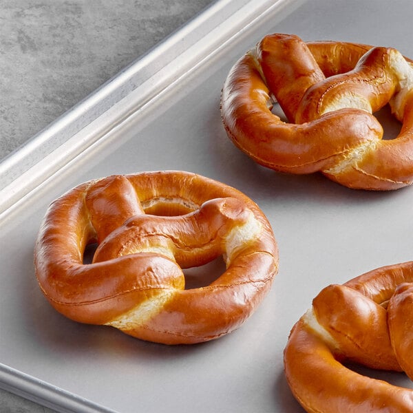 A tray with three J & J Snack Foods SuperPretzel Sourdough Soft Pretzels.