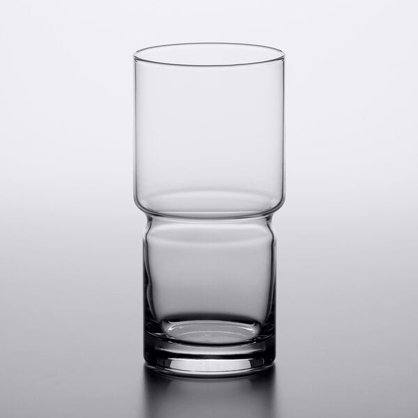 A close-up of a clear Libbey stackable beverage glass with a half empty rim.