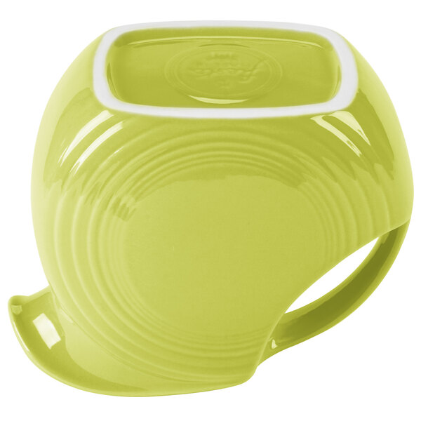 A Fiesta Lemongrass pitcher with a green liquid and a yellow mug.