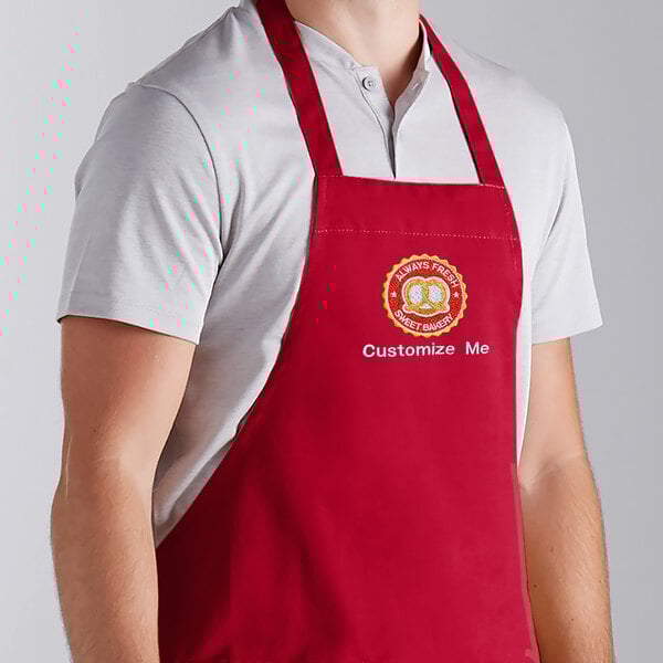 A man wearing a red Choice apron with the company logo in a professional kitchen.