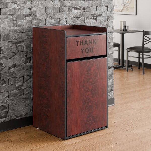A mahogany waste receptacle enclosure with a swing door labeled 'THANK YOU'.