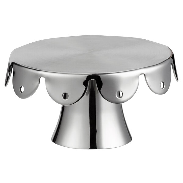 a silver cake stand with a scalloped edge