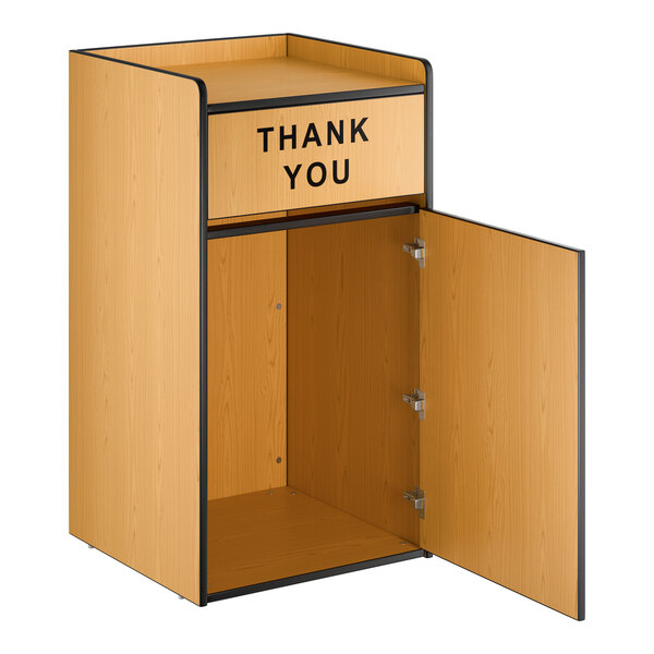 A natural wood waste receptacle enclosure with a 'THANK YOU' swing door and an open cabinet below.