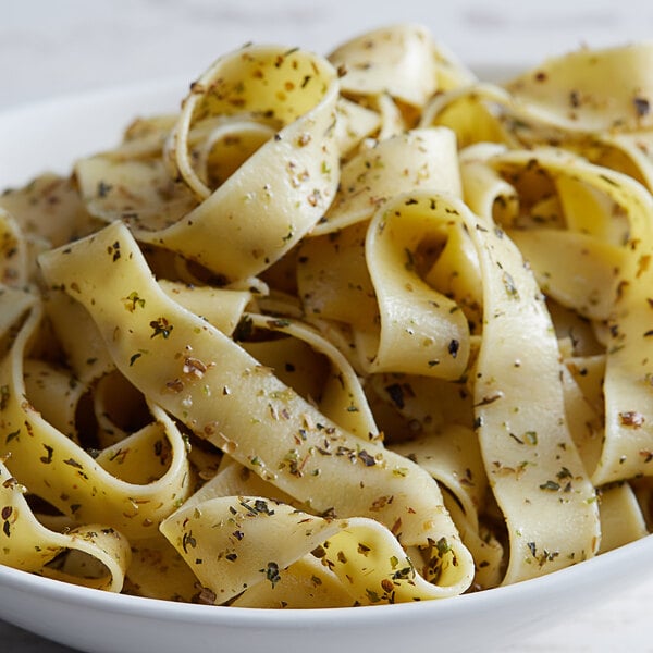 A bowl of Regal pasta with herbs and spices.