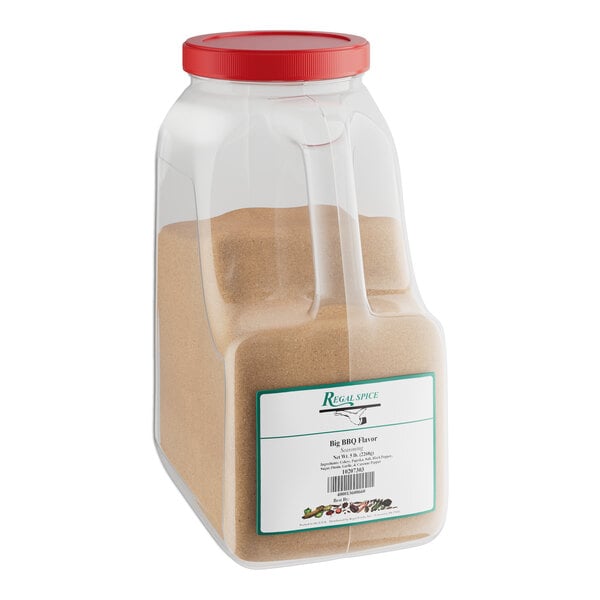 A plastic container of brown powder labeled "Regal Big Flavor BBQ Rub Seasoning"