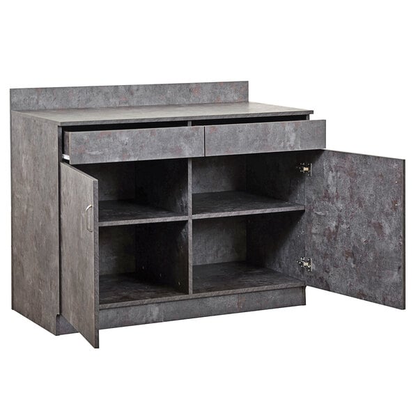 A grey cabinet with two doors and two shelves on a grey counter.