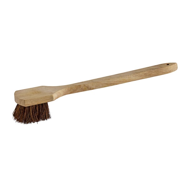 A Carlisle Sparta wok/griddle brush with palmyra bristles and a wooden handle.