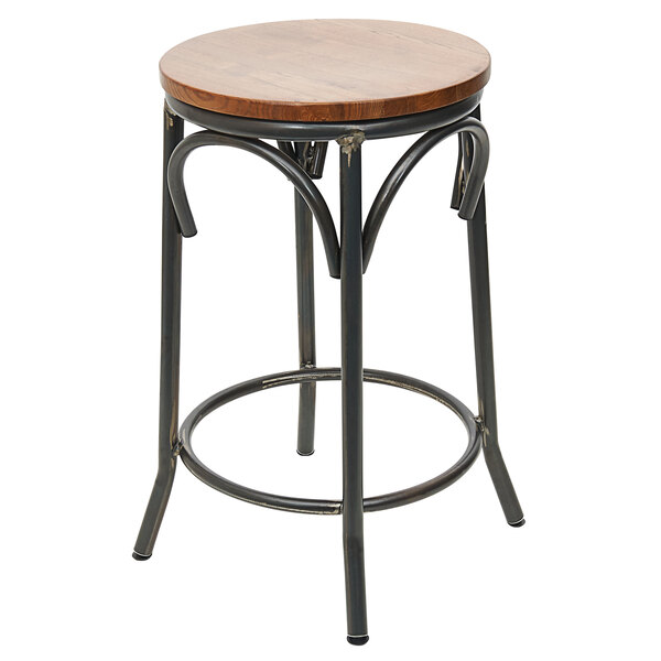 A BFM Seating Henry black metal backless bar stool with a round wooden seat.