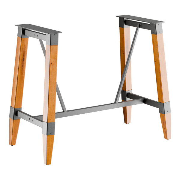 A bar height trestle table base with a honey maple finish and metal supports, designed for 30" x 60" table tops.