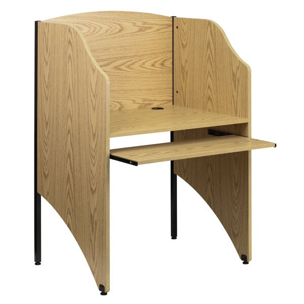 A Flash Furniture oak study carrel with a book stand and shelf.