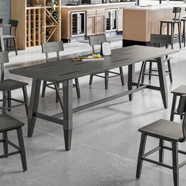 A standard height trestle table with an industrial slate gray finish, designed to support 30" x 96" table tops.