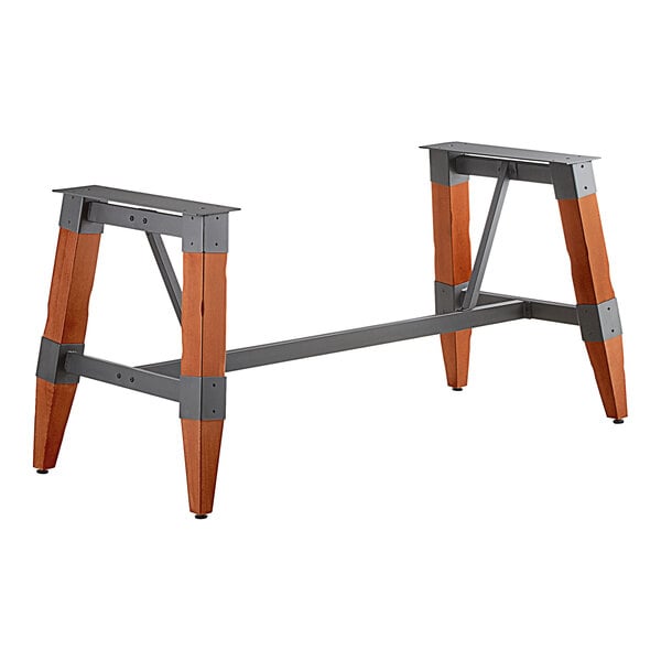 A Lancaster Table & Seating industrial trestle table base with a metal finish and wooden legs.