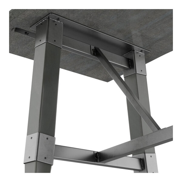 A metal bar height trestle table base with a slate gray finish designed for 30-inch by 60-inch table tops.