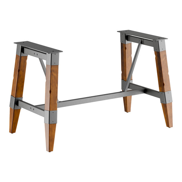 Lancaster Table & Seating industrial rustic walnut trestle table base with metal frame and wooden legs.