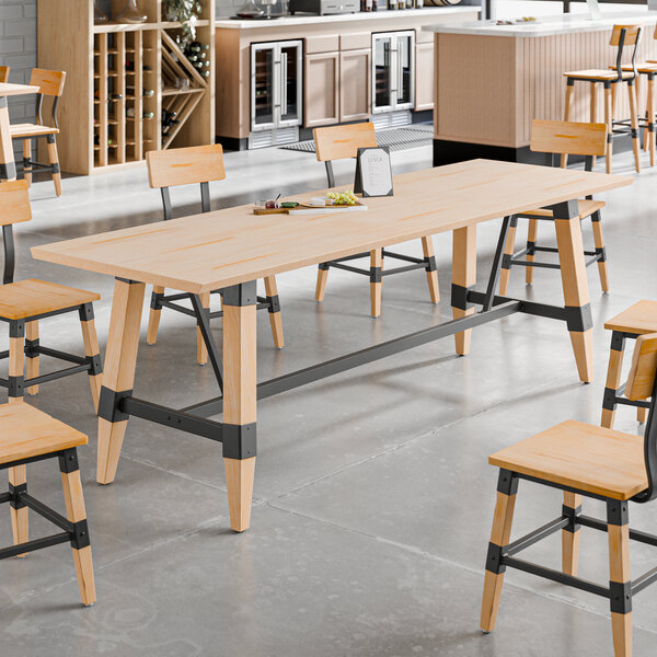 A standard height trestle table with a bleached oak finish and metal supports, designed for 30" x 96" table tops.