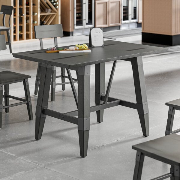 A standard height trestle table with an industrial slate gray finish, designed for 30" x 48" table tops.