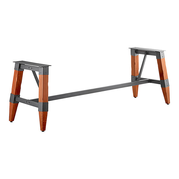 A Lancaster Table & Seating industrial trestle table base with metal legs and a metal long bar.