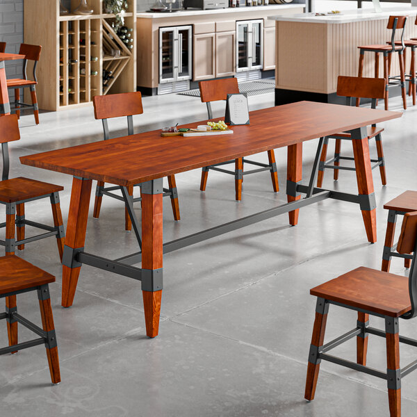 A standard height trestle table with a rustic mahogany finish and industrial metal accents, designed for 30" x 96" table tops.