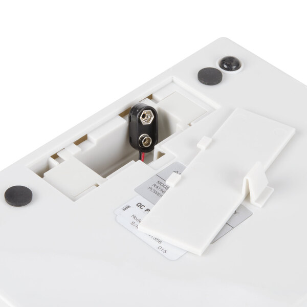 A white Edlund digital portion scale with a black and red cord.