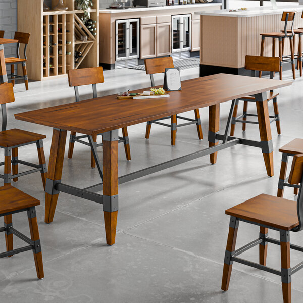 A standard height trestle table with a rustic walnut finish and industrial metal accents, designed for 30" x 96" table tops.