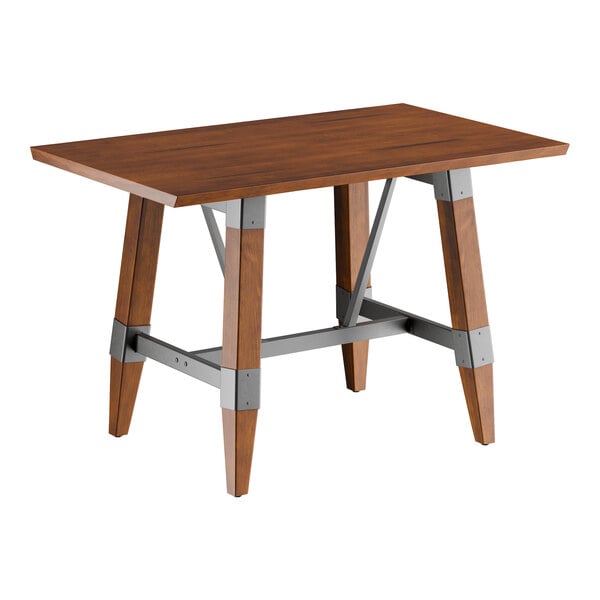A rectangular solid wood table with a rustic walnut finish and a metal trestle base.