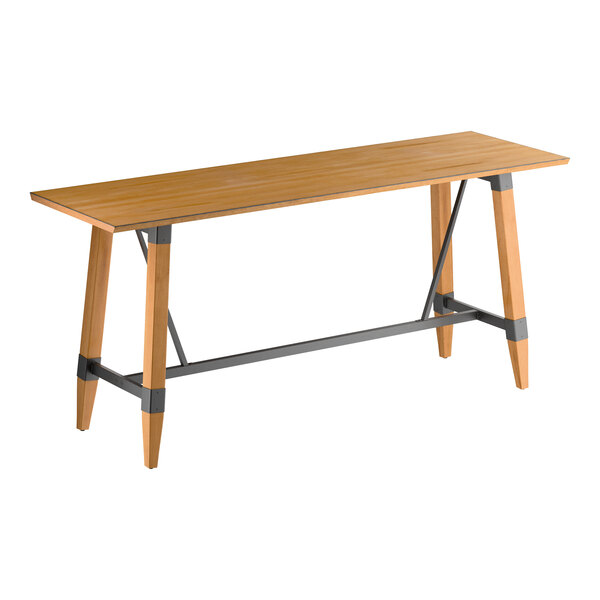 A rectangular wooden bar-height table with a honey maple finish, featuring angled legs and metal support bars.