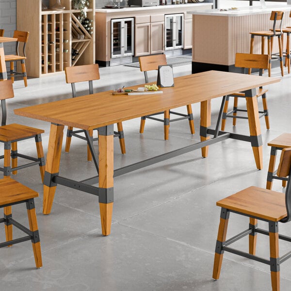 A Lancaster Table & Seating live edge table with chairs in a room