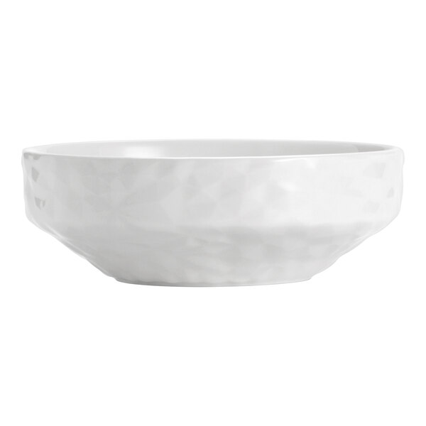A white porcelain bowl with a subtle textured pattern on its exterior.