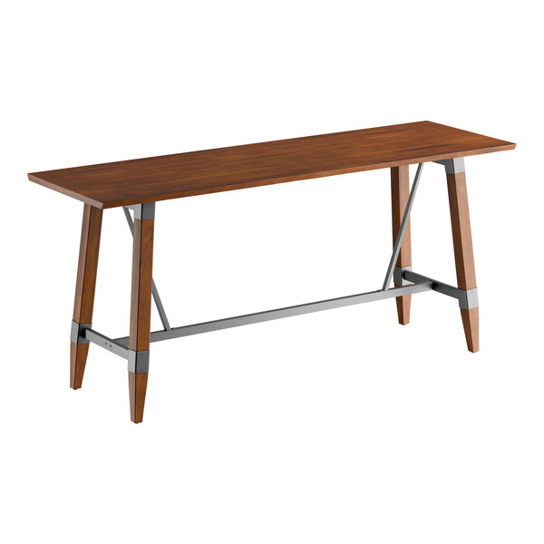 A rectangular bar height table with a solid wood live edge top in a rustic walnut finish and a metal trestle base.