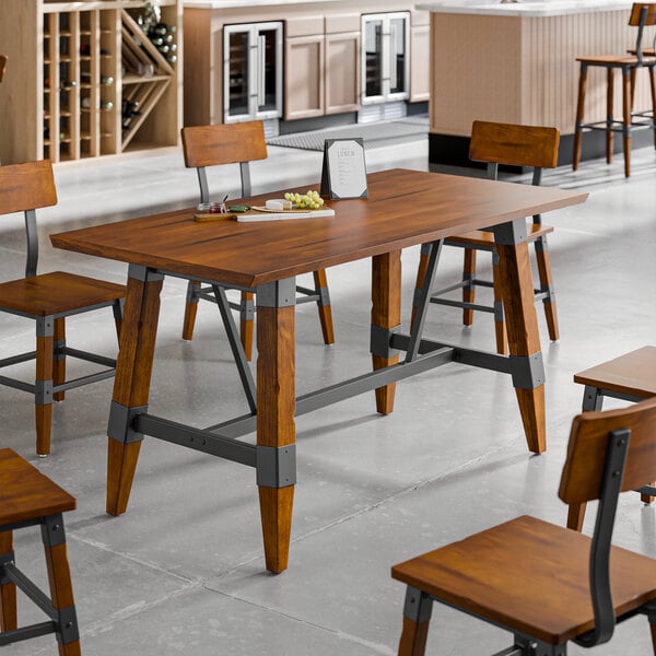 A Lancaster Table & Seating wooden table with a live edge and trestle base.