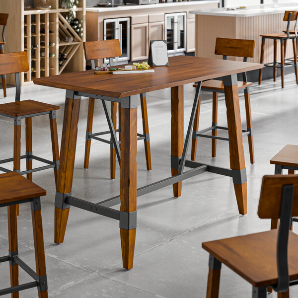 A Lancaster Table & Seating live edge wooden table with a trestle base.