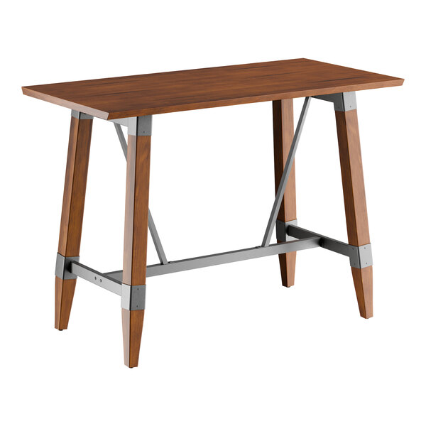 A rectangular bar height table with a solid wood live edge top in a rustic walnut finish and an industrial-style trestle base with metal supports.