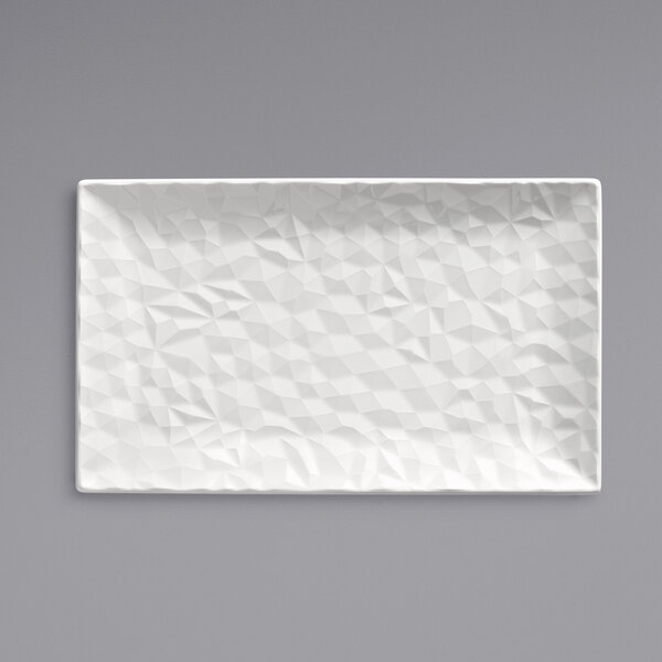 A white rectangular porcelain platter with a triangular pattern.