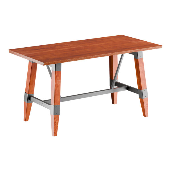 A rectangular solid wood table with a live edge and trestle base, featuring a rustic mahogany finish and metal supports.