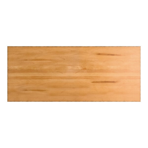 A rectangular wooden surface with a honey maple finish and subtle natural wood grain patterns.