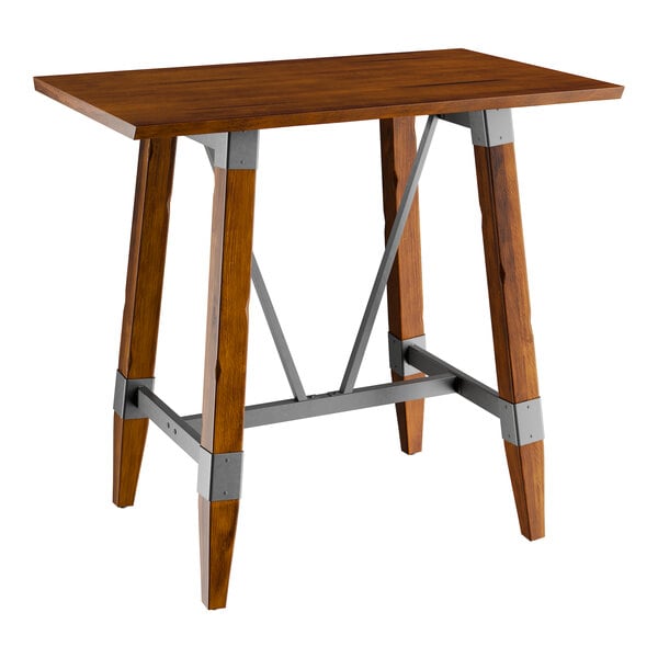 A Lancaster Table & Seating bar height table with a wooden top and metal trestle base.