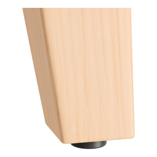 A Lancaster Table & Seating wooden table leg with a black metal base.