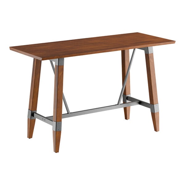 A rectangular bar height table with a solid wood live edge top in a rustic walnut finish and a metal trestle base.