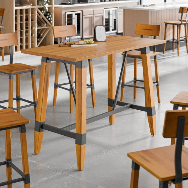 A Lancaster Table & Seating wooden table and chairs with a trestle base.