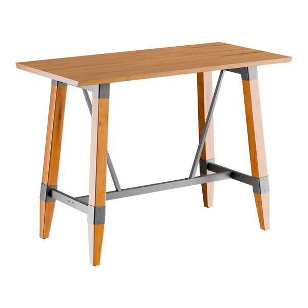 A rectangular bar height table with a solid wood live edge top in a honey maple finish and an industrial-style trestle base with metal supports.